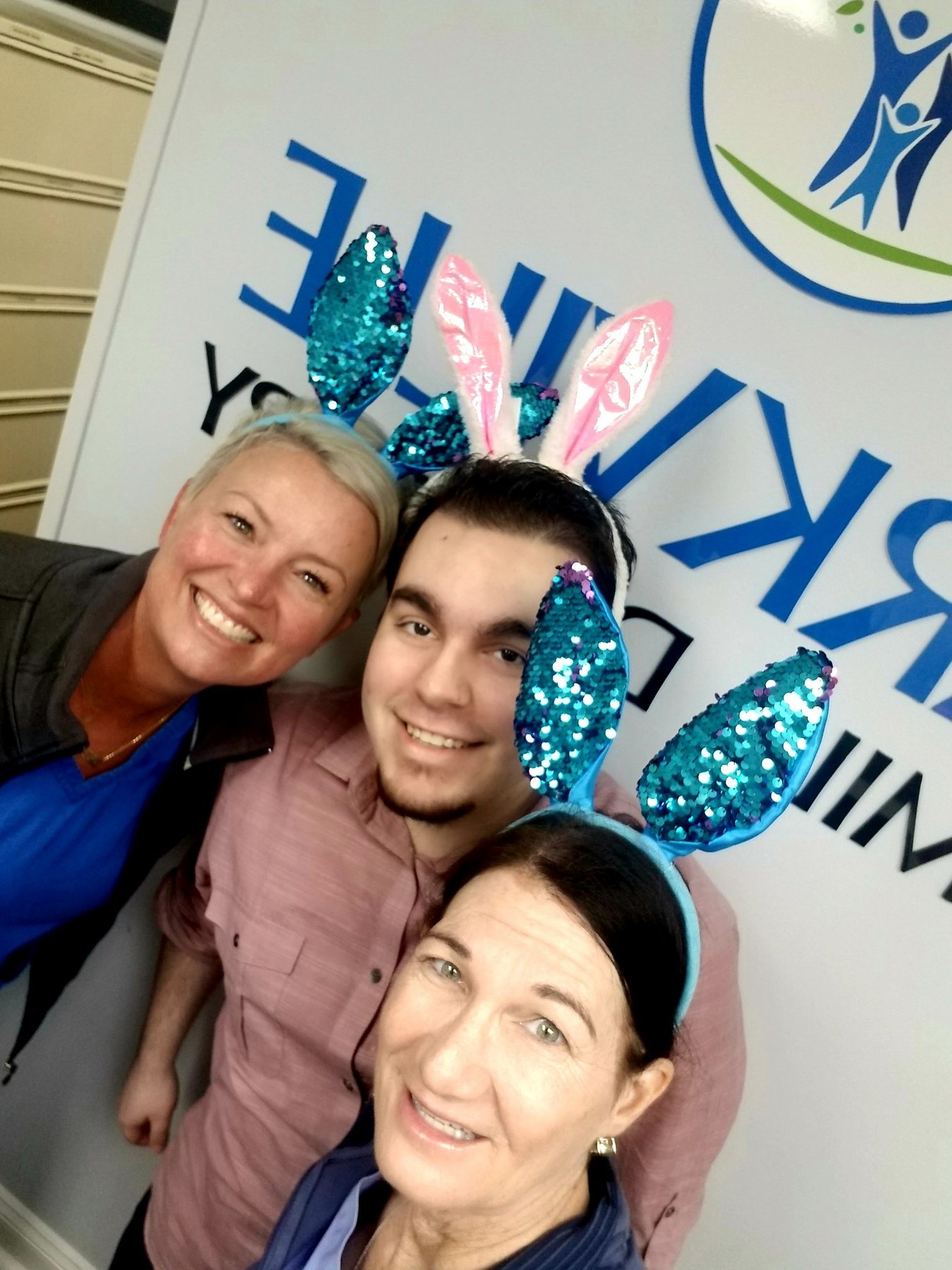 Three Parkville Family Dentistry team members smiling at an event