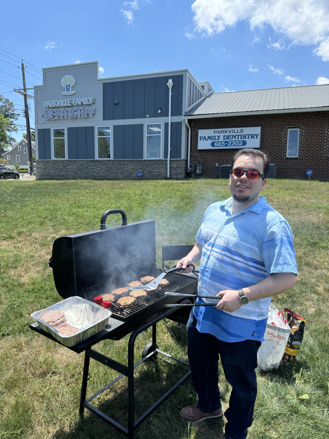 Team member grilling at a Parkville Family Dentistry summer cookout