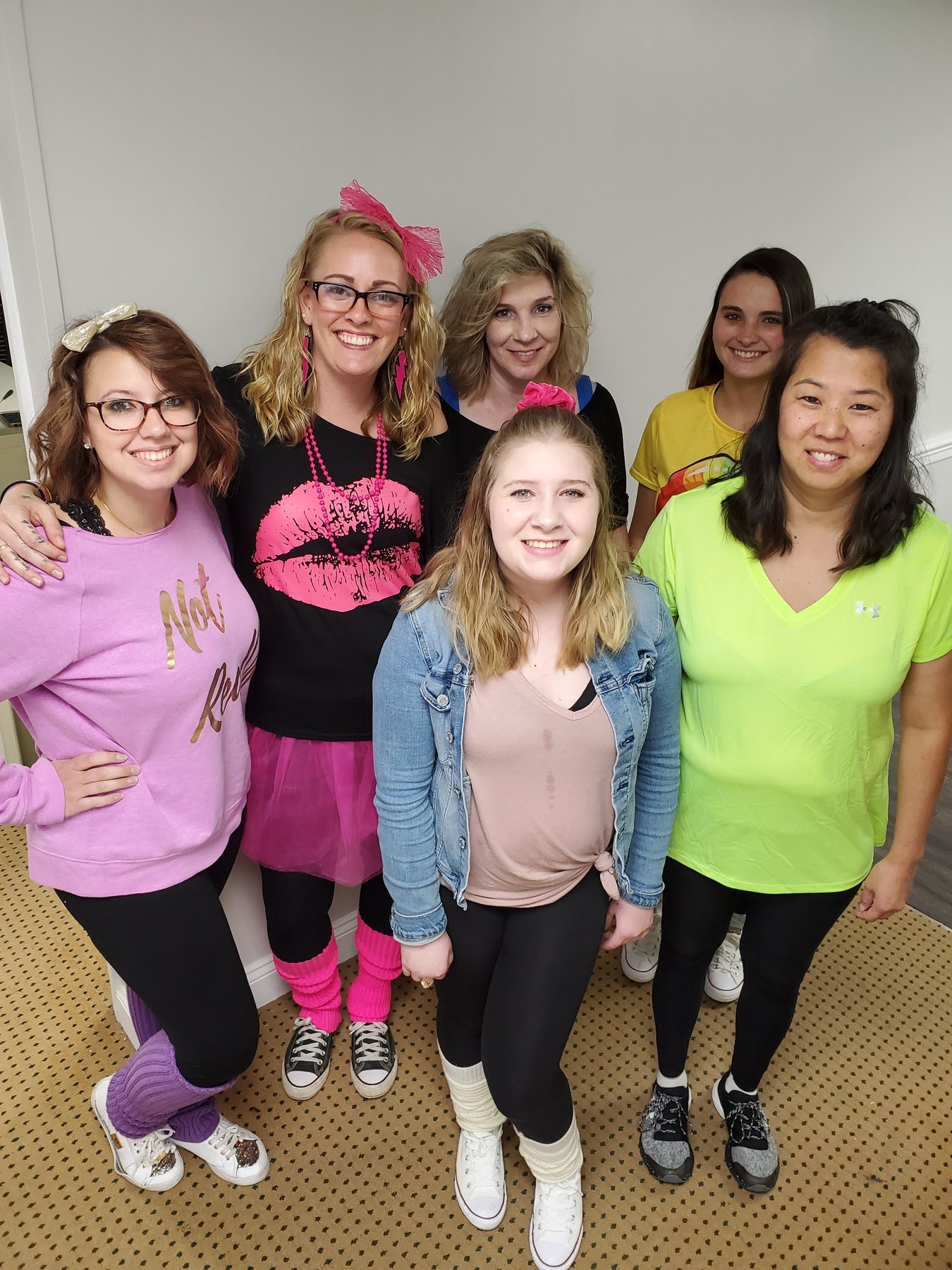 Parkville Family Dentistry team dressed in colorful 1980s outfits