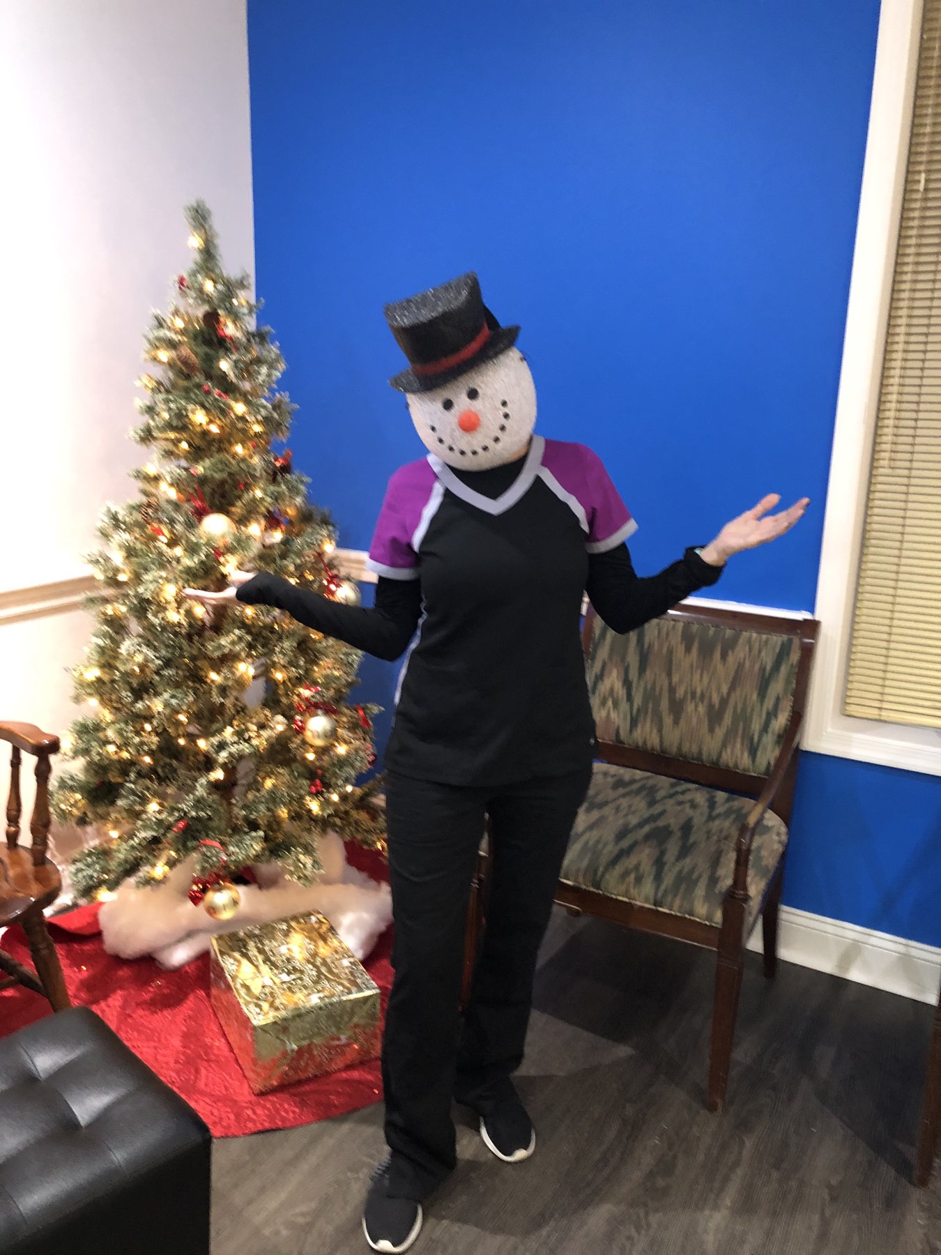 Team member dressed as a snowman during a holiday celebration