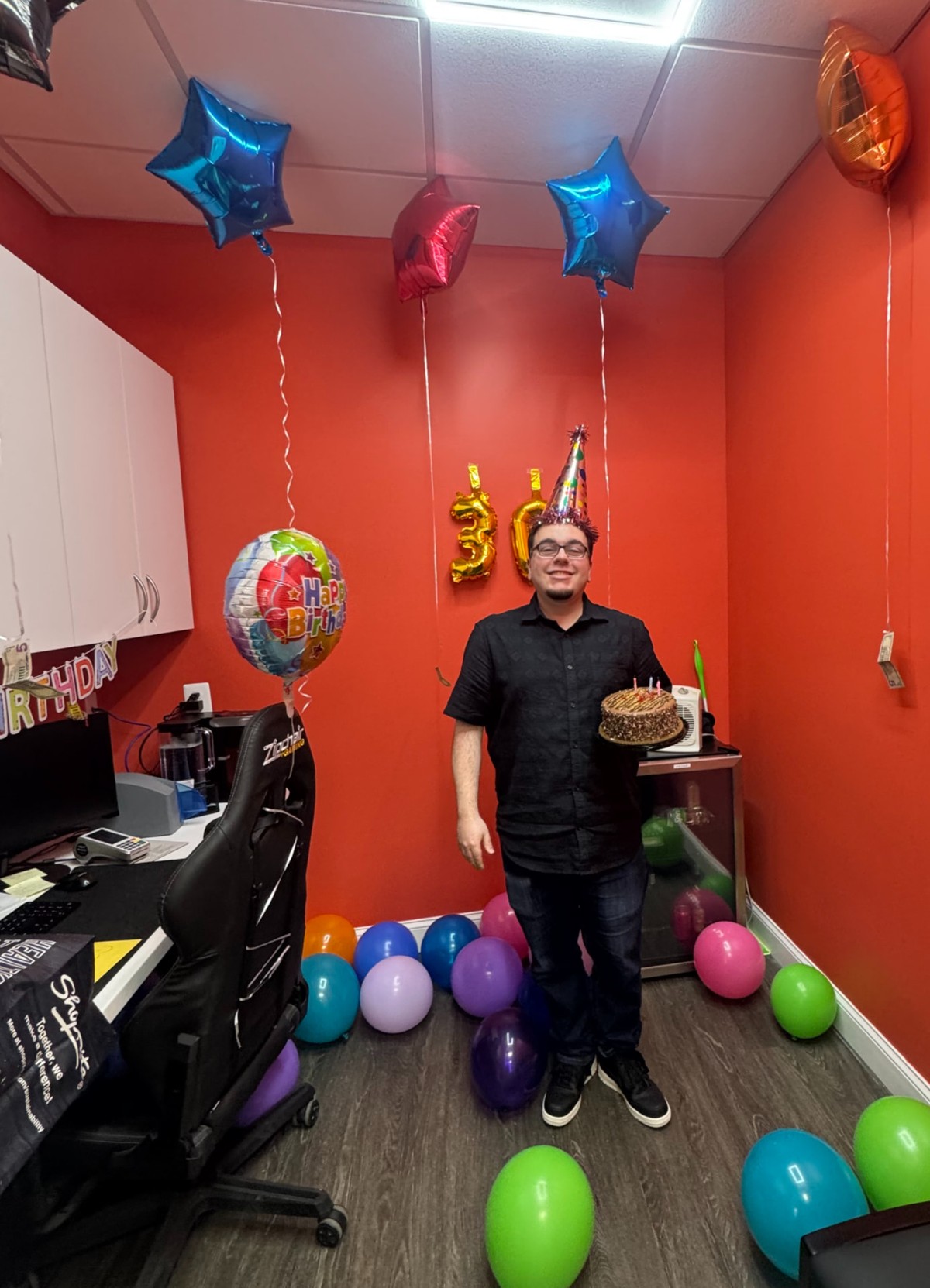 Parkville Family Dentistry office manager celebrating a 30th birthday in the office with balloons and cake